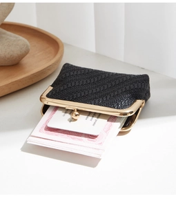 Detail of woven texture coin purse with gold clasp and brand authenticity card