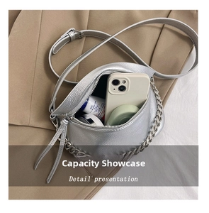 Silver crescent bag interior view showing capacity for phone, cream and makeup items