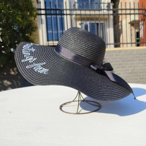 Black straw sun hat with white Greetings from embroidery and black ribbon bow for women