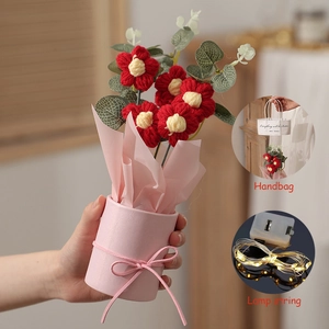 Detailed view of handmade crochet flower bouquet in a pink pot with warm LED lights