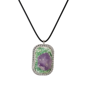 Geometric amethyst heart pendant with green gems and black cord on white background