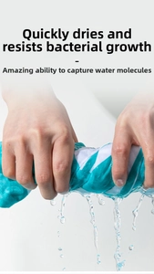 Detail showing hand wringing water from quick-dry striped beach towel with high absorption
