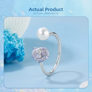 Detailed close-up of S925 silver open ring with pearl and blue conch shell detail