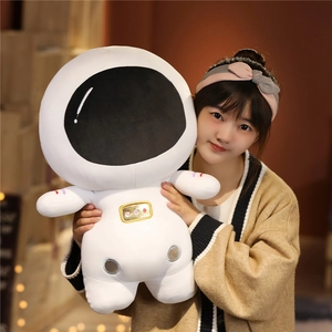 Close-up of a large soft plush astronaut toy showing detailed embroidery and soft texture