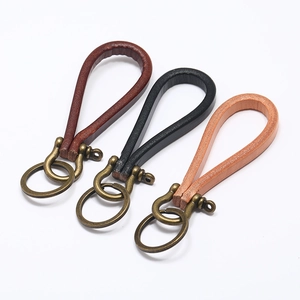 Handmade vintage leather keychains in brown, black, and tan with bronze horseshoe clasps