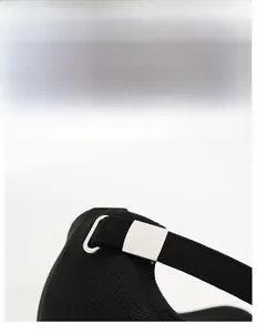 Close-up of adjustable metal buckle and breathable knit texture on black baseball cap