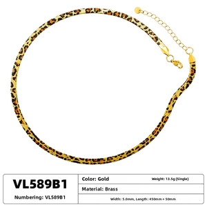 Detailed macro view of 5mm gold brass snake chain necklace with leopard print finish