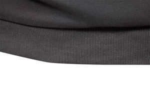 Macro shot of dark grey ribbed knit texture and stitching detail on the sleeve cuff