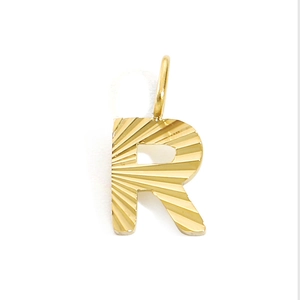 Detailed view of golden letter R pendant with radial texture and polished metal finish