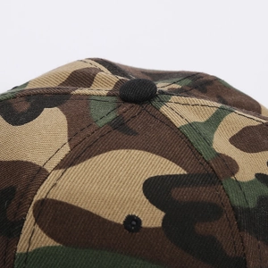 Macro shot of camo baseball cap top showing black button and reinforced stitching details