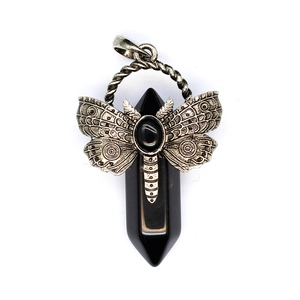 Macro view of vintage dragonfly wrap on hexagonal rainbow fluorite crystal pendant