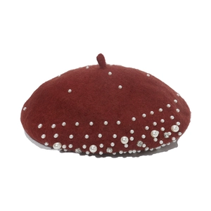 Detail of wool beret in burgundy with white pearls and sparkling rhinestone accents