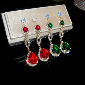 Elegant gold drop earrings with red and green pear-cut crystals and diamond accents