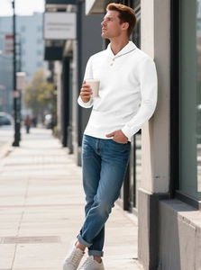 Close-up of men's white waffle knit sweater featuring textured fabric and buttoned shawl collar