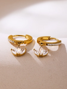 Close-up of gold clover earrings with marquise-cut zircon stones and 18K PVD finish