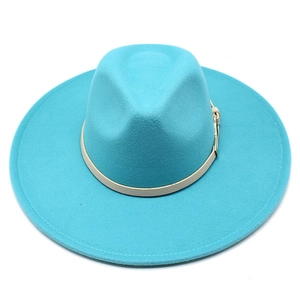 Detail of turquoise wool fedora hat featuring a beige leather band and metal buckle