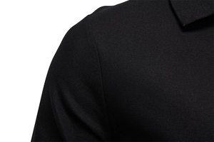 Macro shot of black men's piqué polo shirt showing shoulder seam and collar texture