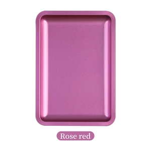 Polished rose red rectangular stainless steel jewelry tray in a clean macro view