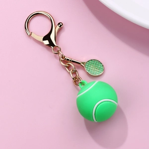 Detailed view of green tennis racket and ball keychain with a gold lobster clasp