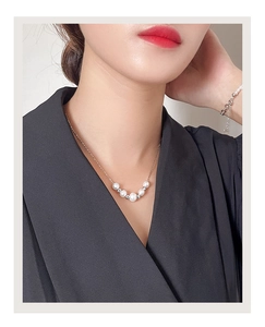 Close-up of minimalist S925 silver necklace and bracelet with white freshwater pearls