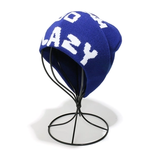 Close-up of royal blue knit beanie featuring white LAZY jacquard text and ribbed texture