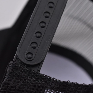 Detail view of black snapback closure and mesh fabric on a trucker baseball cap