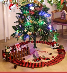 Detail of burlap Christmas tree skirt with buffalo plaid edge and red truck embroidery