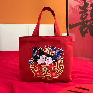 Red canvas wedding gift bag with cartoon bride and groom illustration for guests