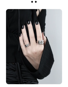 Macro detail of S925 sterling silver rings with irregular texture on a model's hand