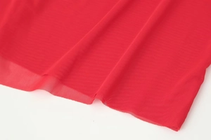 Macro detail of red translucent mesh fabric showing breathable texture and fine knit