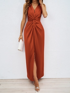 Detail of elegant V-neck knot waist and high slit design on a rust red satin maxi dress