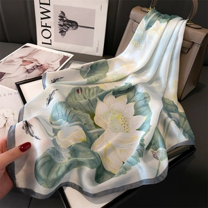 Elegant silk scarf with white lotus and green lily pads print on light blue background