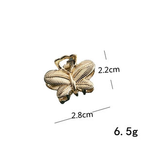 Detail view of mini gold butterfly hair claw clip with dimensions 2.2cm by 2.8cm