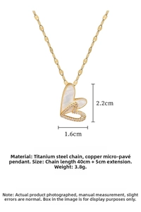 Macro shot of double hollow heart pendant with sparkling pavé crystals and gold finish