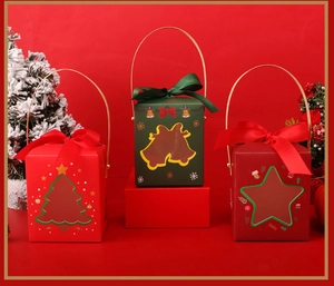 Close-up of Christmas gift boxes with festive cutout windows and gold handles