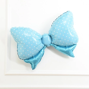 Large blue bow-shaped aluminum foil balloon with white polka dots for birthday parties