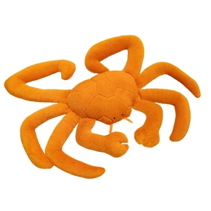 Realistic orange king crab plush toy with soft fabric and long legs on white background
