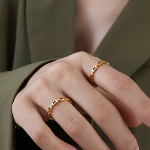 Minimalist 18K gold plated hollow link chain rings worn by a model in a luxury style