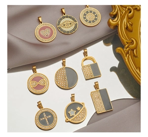 Macro shot of gold-plated rectangular pendants with colorful enamel and inlaid rhinestones