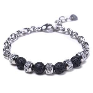 Macro view of lava rock beads and intricate hollow metal beads on a steel bracelet
