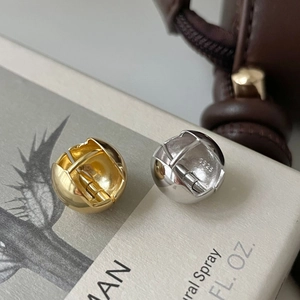 Macro view of S925 sterling silver ball hoop earrings showing high-polished finish
