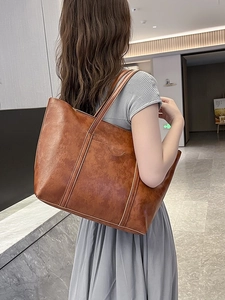 Brown vintage oil wax leather handbag set with shoulder straps shown on a model