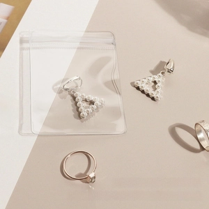 Close-up of thick anti-oxidation jewelry storage bag with clear pearl earrings inside