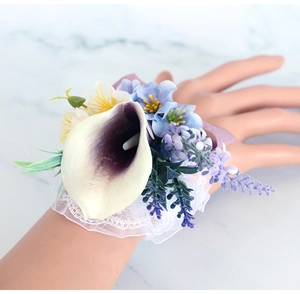 Wrist corsage with white calla lily and blue daisies for bridesmaids and wedding guests