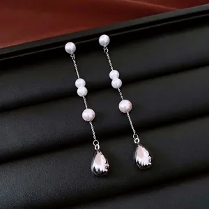 French vintage pearl drop tassel earrings on a premium black leather jewelry display tray