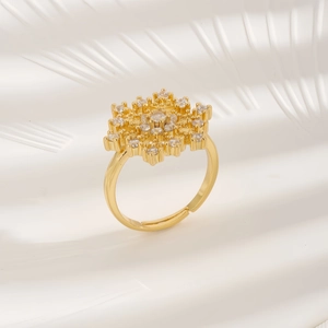 Luxurious snowflake ring with clear zircons and adjustable gold band on soft silk fabric