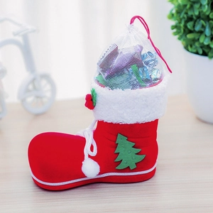 Detail of red flocked Christmas boot candy jar with white faux fur and mesh drawstring