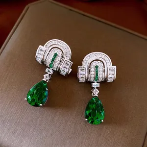 Silver drop earrings with vintage green pear-shaped zircon and curved brushed metal finish