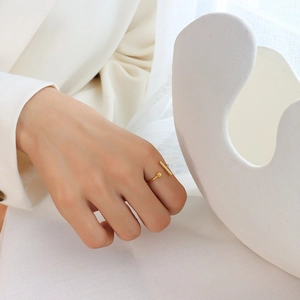 Minimalist gold T-shaped open ring made of titanium steel on female index finger