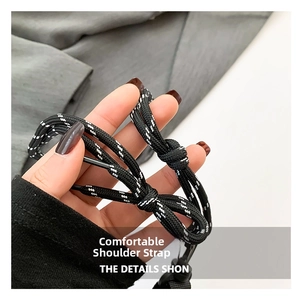 Detail view of durable black and white braided rope shoulder strap with nylon texture